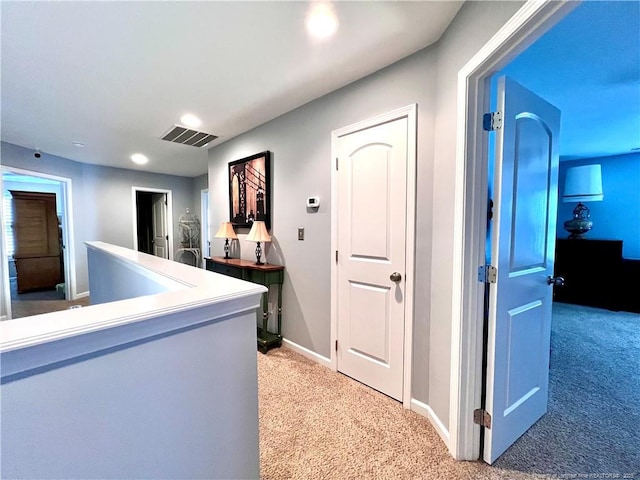 hall with light carpet, baseboards, visible vents, and recessed lighting