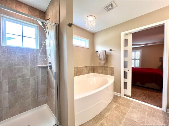 ensuite bathroom with baseboards, ensuite bath, a shower stall, visible vents, and a garden tub
