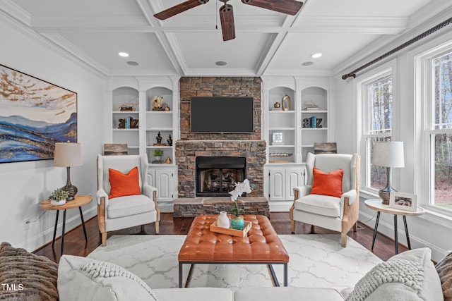 living room with coffered ceiling, wood finished floors, ceiling fan, and a fireplace