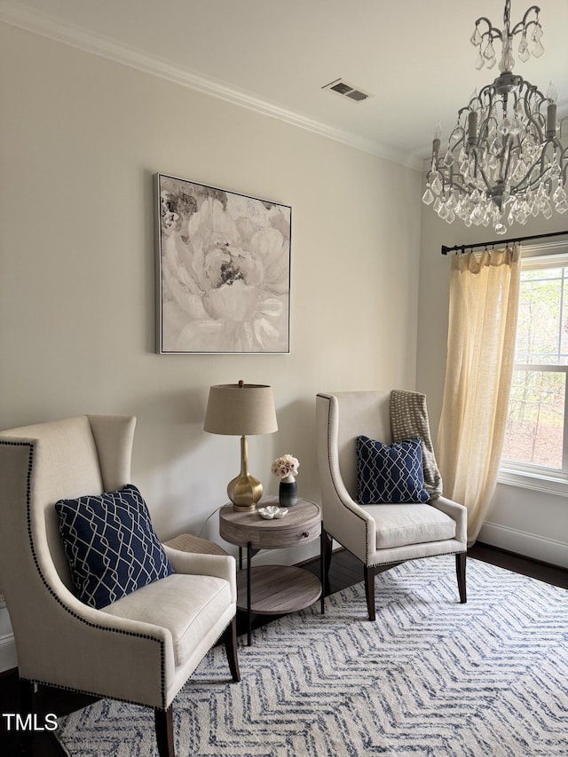 sitting room with crown molding, visible vents, baseboards, and wood finished floors