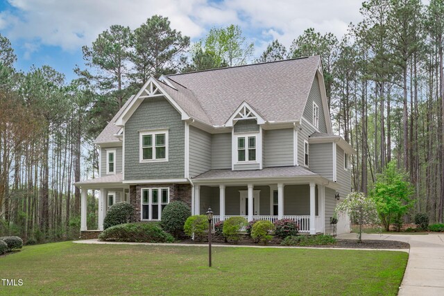 2408 Merion Creek Dr, Apex, NC 27539 - craftsman-style house with a porch, a front lawn, concrete driveway, and stone siding