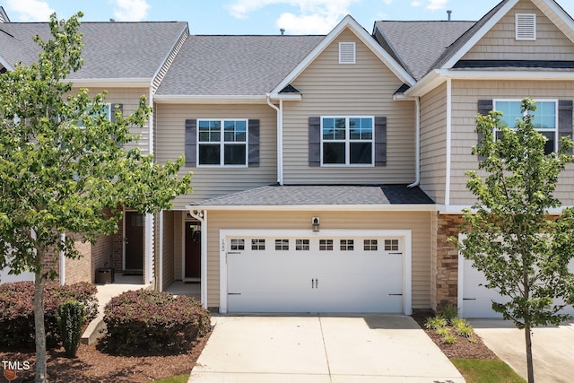 122 Torpoint Rd, Durham, NC 27703 - view of property with an attached garage, concrete driveway, roof with shingles, and stone siding