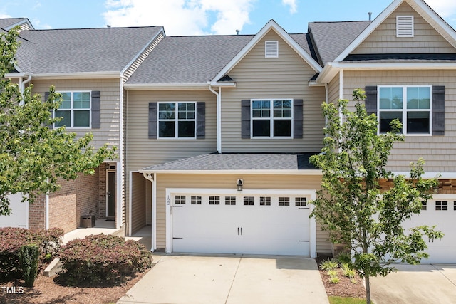 122 Torpoint Rd, Durham, NC 27703 - multi unit property with concrete driveway, an attached garage, and a shingled roof