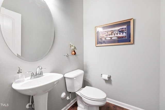 122 Torpoint Rd, Durham, NC 27703 - half bathroom featuring baseboards and wood finished floors