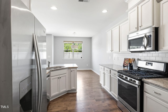 122 Torpoint Rd, Durham, NC 27703 - kitchen featuring stainless steel appliances, dark wood-style floors, white cabinetry, recessed lighting, and backsplash