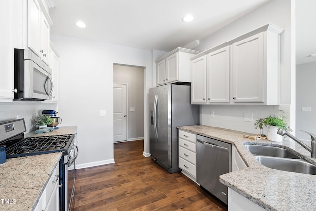 122 Torpoint Rd, Durham, NC 27703 - kitchen featuring stainless steel appliances, decorative backsplash, white cabinets, light stone countertops, and recessed lighting