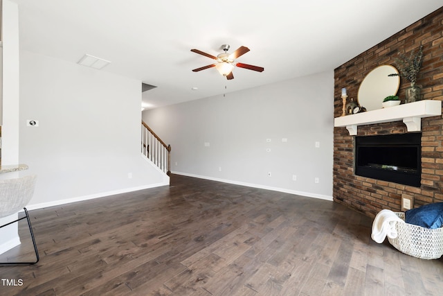122 Torpoint Rd, Durham, NC 27703 - unfurnished living room featuring ceiling fan, wood finished floors, stairway, and a brick fireplace