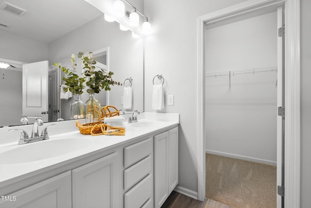 122 Torpoint Rd, Durham, NC 27703 - full bathroom featuring double vanity, a spacious closet, and wood finished floors