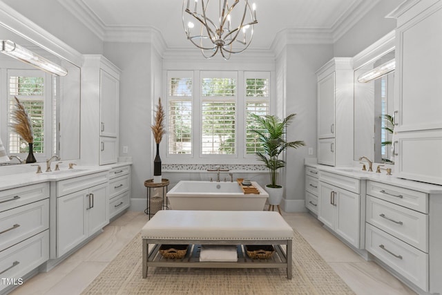 1208 Hunting Ridge Rd, Raleigh, NC 27615 - full bath featuring two vanities, plenty of natural light, a freestanding tub, a chandelier, and crown molding