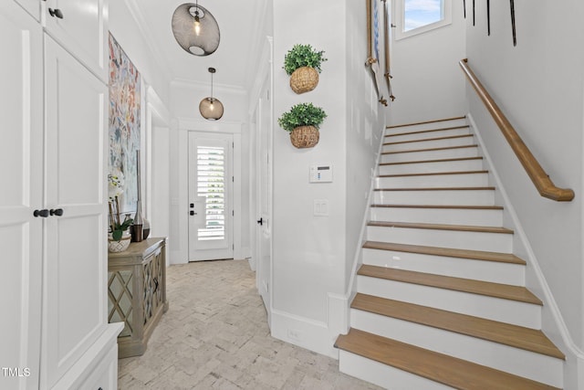 1208 Hunting Ridge Rd, Raleigh, NC 27615 - entryway with stairway, brick flooring, ornamental molding, and baseboards
