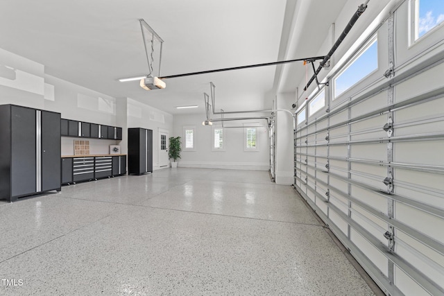 1208 Hunting Ridge Rd, Raleigh, NC 27615 - garage with a garage door opener and baseboards