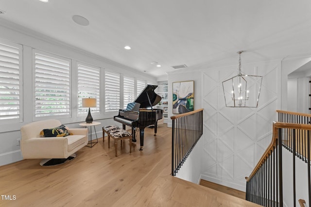 1208 Hunting Ridge Rd, Raleigh, NC 27615 - sitting room with an upstairs landing, a chandelier, wood finished floors, ornamental molding, and baseboards