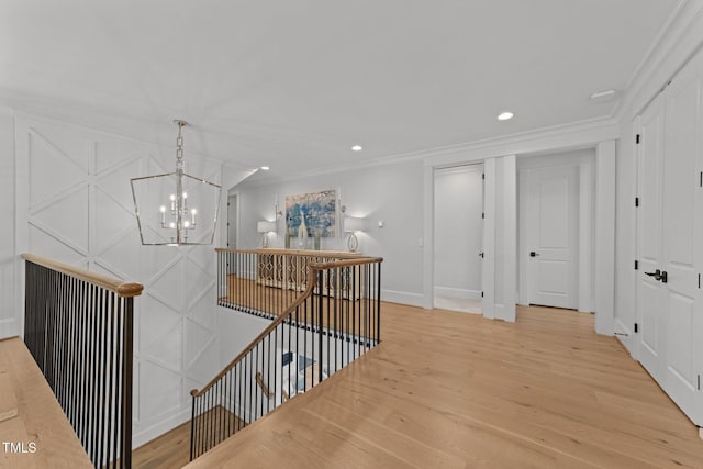 1208 Hunting Ridge Rd, Raleigh, NC 27615 - corridor with an upstairs landing, a chandelier, light wood-style flooring, ornamental molding, and baseboards