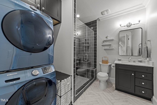 1208 Hunting Ridge Rd, Raleigh, NC 27615 - bathroom with stacked washing machine and dryer, toilet, vanity, a shower stall, and baseboards