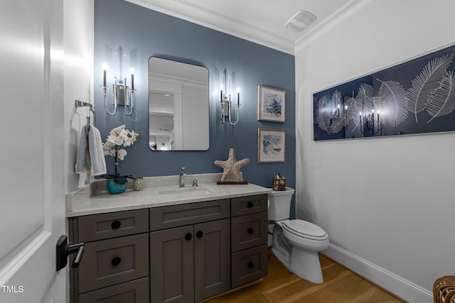 1208 Hunting Ridge Rd, Raleigh, NC 27615 - half bath featuring wood finished floors, toilet, vanity, crown molding, and baseboards