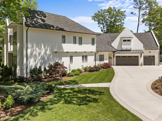 1208 Hunting Ridge Rd, Raleigh, NC 27615 - view of front of home with driveway, an attached garage, a front yard, and roof with shingles