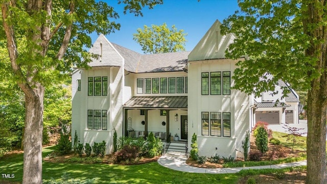 1208 Hunting Ridge Rd, Raleigh, NC 27615 - view of front of property with a standing seam roof, a front yard, a porch, metal roof, and roof with shingles