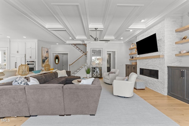 1208 Hunting Ridge Rd, Raleigh, NC 27615 - living room with a fireplace, light wood-style flooring, stairway, ornamental molding, and a ceiling fan