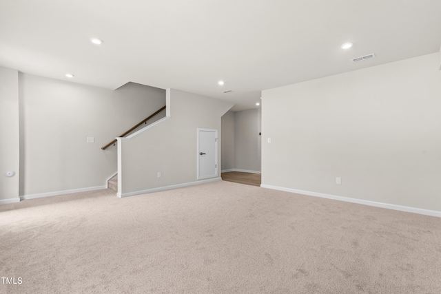 605 Silverado Sunset Loop, Wendell, NC 27591 - unfurnished living room featuring stairway, light colored carpet, recessed lighting, and baseboards