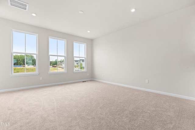 605 Silverado Sunset Loop, Wendell, NC 27591 - spare room with light colored carpet, plenty of natural light, baseboards, and recessed lighting
