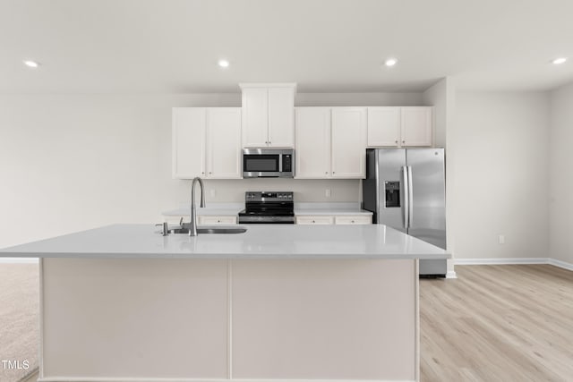 605 Silverado Sunset Loop, Wendell, NC 27591 - kitchen with stainless steel appliances, a sink, white cabinetry, an island with sink, and baseboards