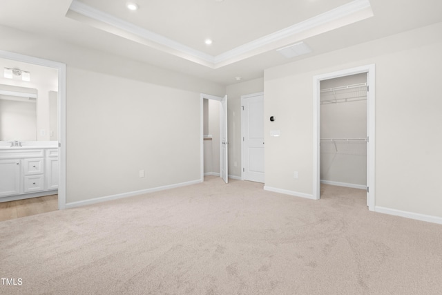605 Silverado Sunset Loop, Wendell, NC 27591 - unfurnished bedroom featuring a raised ceiling, a sink, light colored carpet, recessed lighting, and crown molding