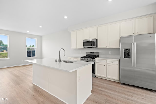 609 Silverado Sunset Loop, Wendell, NC 27591 - kitchen with stainless steel appliances, a sink, light wood-type flooring, a center island with sink, and recessed lighting