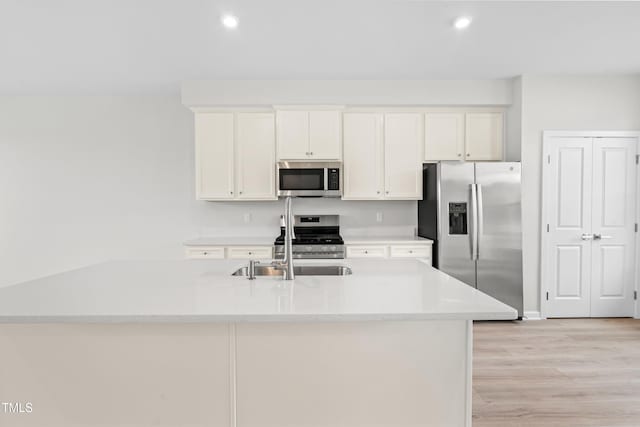 609 Silverado Sunset Loop, Wendell, NC 27591 - kitchen featuring stainless steel appliances, light wood-style floors, white cabinets, recessed lighting, and light countertops