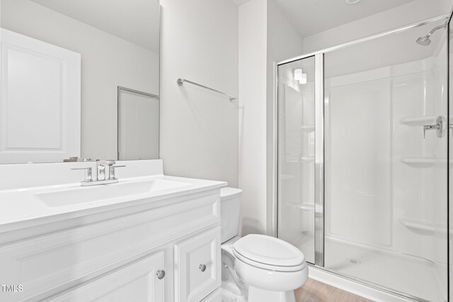 609 Silverado Sunset Loop, Wendell, NC 27591 - full bath featuring a stall shower, toilet, vanity, and wood finished floors