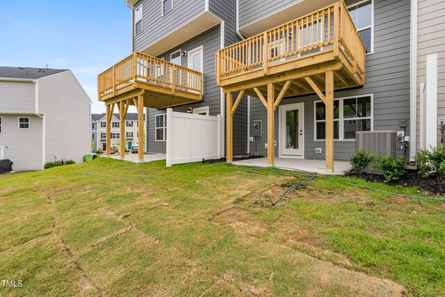 609 Silverado Sunset Loop, Wendell, NC 27591 - back of property with central AC unit, a patio, a yard, and a wooden deck