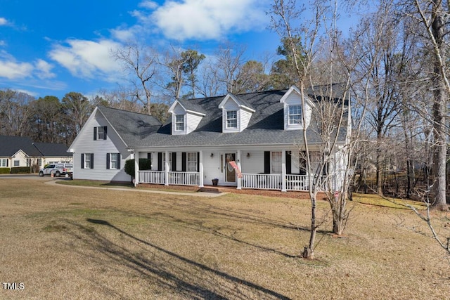 cape cod house with covered porch and a front lawn