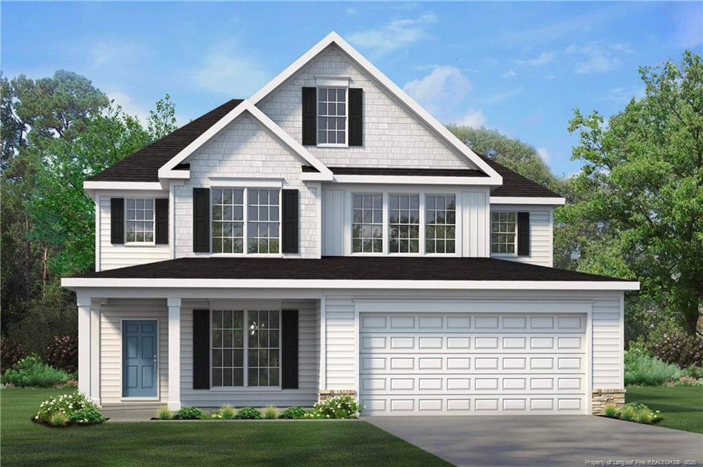 view of front of property with a front yard, driveway, and a garage