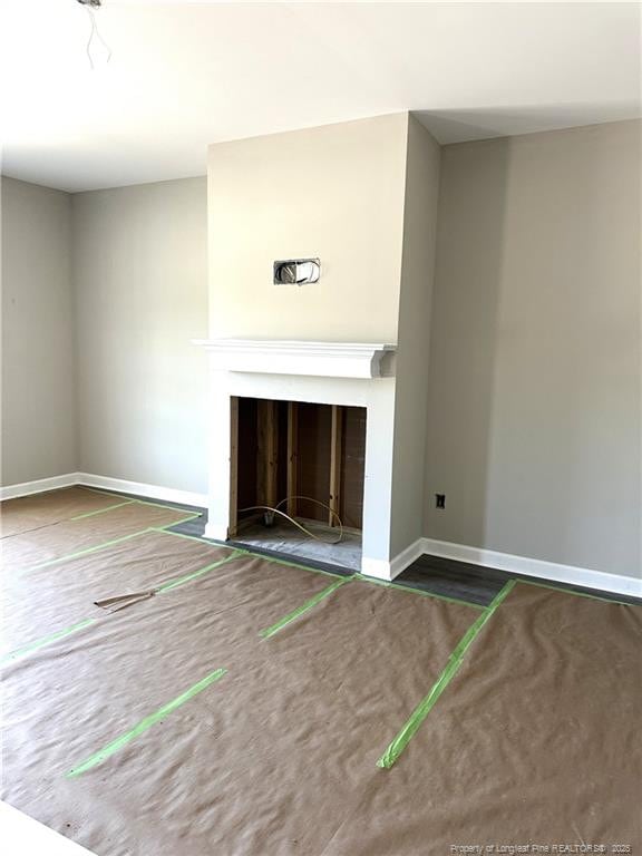 254 Dalton Dr, Lumber Bridge, NC 28357 - unfurnished living room featuring a fireplace and baseboards