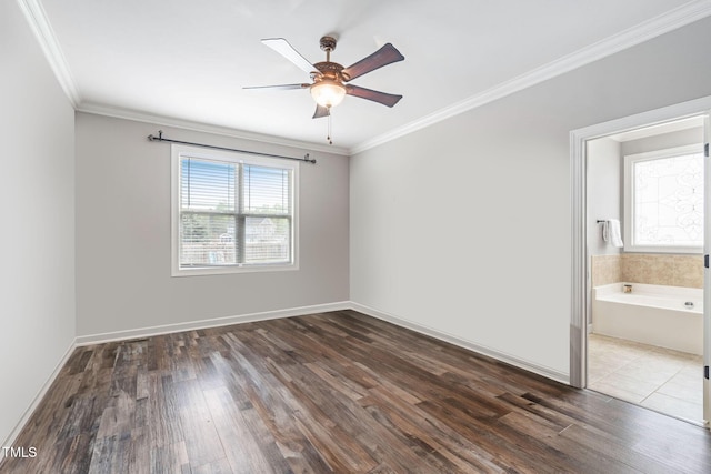unfurnished room featuring dark wood finished floors, crown molding, a ceiling fan, and baseboards