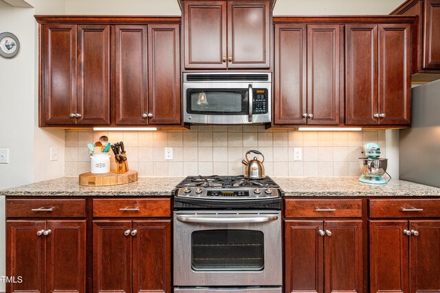 2739 Elderberry Ln, Apex, NC 27539 - kitchen with stainless steel appliances, backsplash, and light stone counters