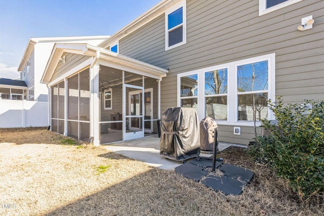 back of property with a patio, a sunroom, and fence