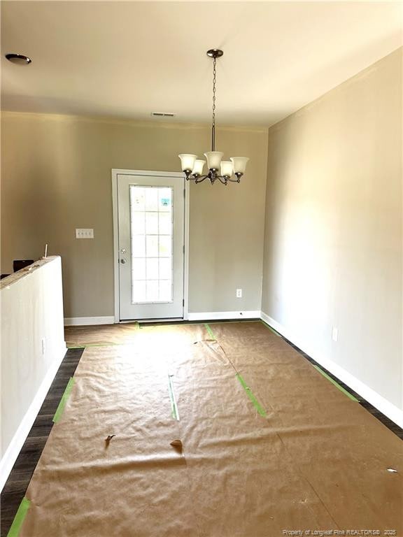 236 Dalton Dr, Lumber Bridge, NC 28357 - unfurnished dining area with a chandelier and baseboards