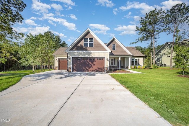 104 Roma Gora Ct, Princeton, NC 27569 - craftsman-style home featuring a front yard, concrete driveway, a porch, an attached garage, and stone siding