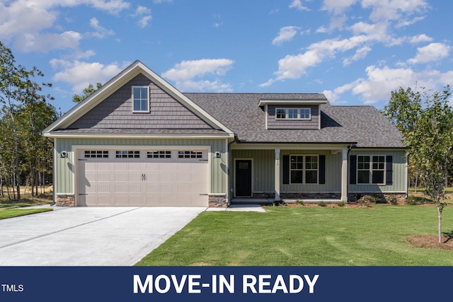 view of front of property with driveway, a front yard, a porch, a garage, and a shingled roof