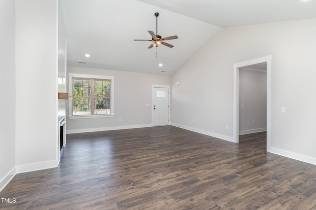 unfurnished living room featuring dark wood-style floors, baseboards, vaulted ceiling, and ceiling fan