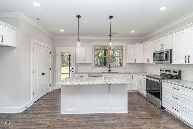 kitchen featuring appliances with stainless steel finishes, a sink, white cabinetry, and visible vents
