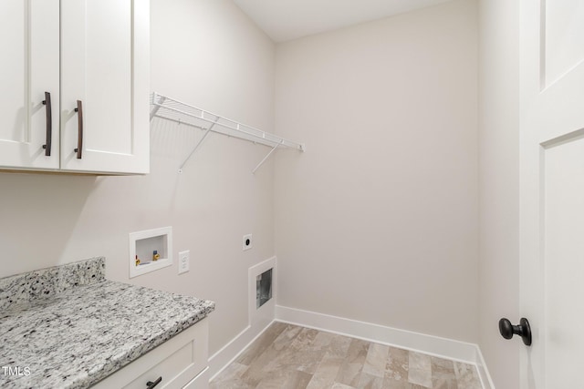 clothes washing area with electric dryer hookup, baseboards, hookup for a washing machine, and cabinet space