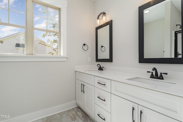 full bathroom featuring a sink, baseboards, and a healthy amount of sunlight