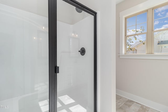 full bath with baseboards and a stall shower