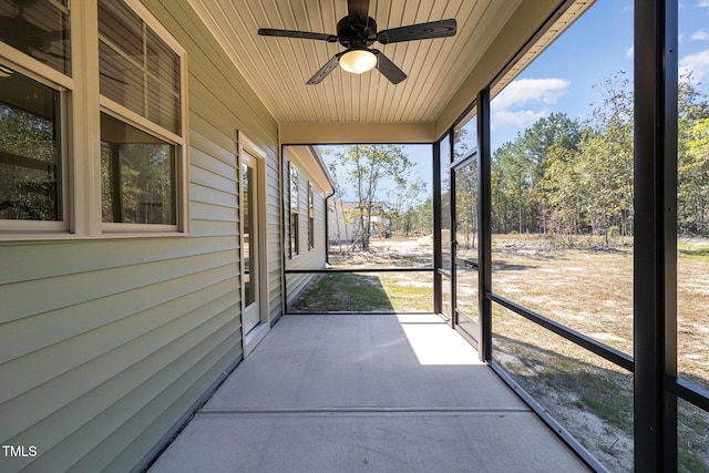 unfurnished sunroom featuring ceiling fan