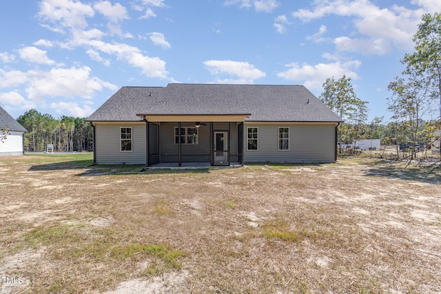 back of house with a shingled roof and a ceiling fan