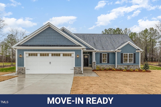 craftsman house with board and batten siding, an attached garage, stone siding, and concrete driveway