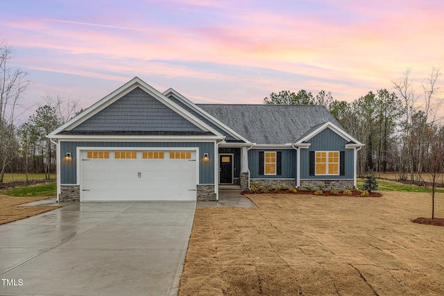 craftsman inspired home with board and batten siding, stone siding, and driveway