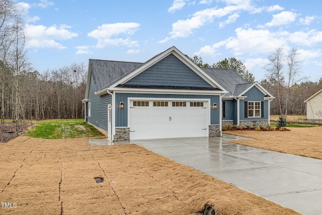 craftsman-style house with driveway, board and batten siding, a garage, and stone siding