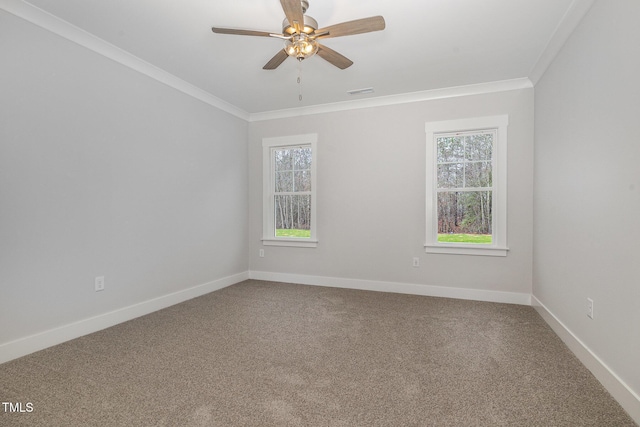 carpeted empty room with crown molding, visible vents, and a wealth of natural light